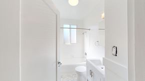 San Francisco apartment for rent - A white bathroom with a toilet, sink, and bathtub.