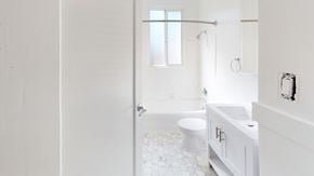 San Francisco apartment for rent - A white bathroom with a toilet, sink, and shower.