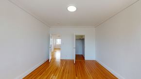 San Francisco apartment for rent - A long hallway with wood floors and white walls.