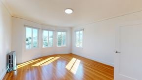 San Francisco apartment for rent - A room with a wooden floor and a white ceiling with a window.