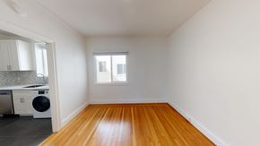 San Francisco apartment for rent - A room with wooden floors and white walls.