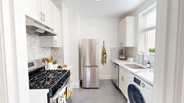 San Francisco apartment for rent - A modern kitchen with a stove, refrigerator, and washing machine.