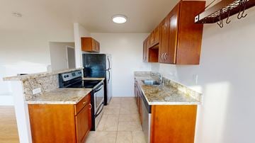 San Francisco apartment for rent - A kitchen with wooden cabinets and granite countertops.