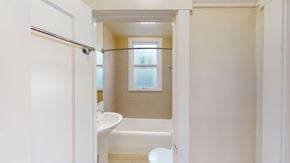 San Francisco apartment for rent - A white bathroom with a tub and toilet.