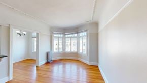 San Francisco apartment for rent - A room with wooden floors and white walls.