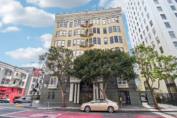 San Francisco apartment for rent - A white car is parked on the street in front of a building.