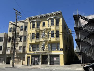 San Francisco apartment for rent - A yellow building with a black car parked in front.
