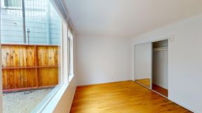 San Francisco apartment for rent - A room with wooden floors and a sliding glass door.