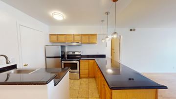 San Francisco apartment for rent - A kitchen with a black countertop and wooden cabinets.