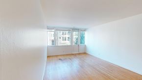 San Francisco apartment for rent - A room with a window and wooden floors.