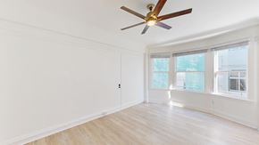 San Francisco apartment for rent - A room with a ceiling fan and a door.