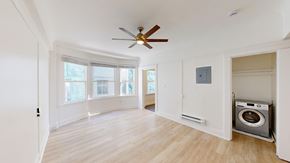 San Francisco apartment for rent - A room with a ceiling fan and a washing machine in it.