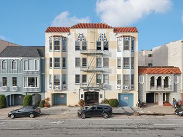 San Francisco apartment for rent - A row of three-story buildings with balconies and garage doors.