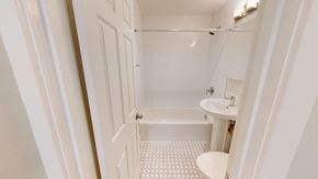 San Francisco apartment for rent - A white bathroom with a shower, sink and toilet.