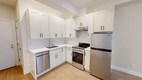 San Francisco apartment for rent - A kitchen with white cabinets and stainless steel appliances.