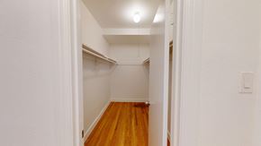 San Francisco apartment for rent - A hallway with a light on the ceiling and a wooden floor.