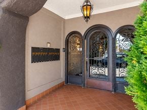 San Francisco apartment for rent - A building entrance with a black gate and a lantern hanging from the ceiling.