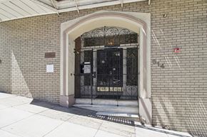 San Francisco apartment for rent - A building with a brick wall and a metal gate.