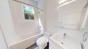 San Francisco apartment for rent - A white bathroom with a toilet, sink, and tub.