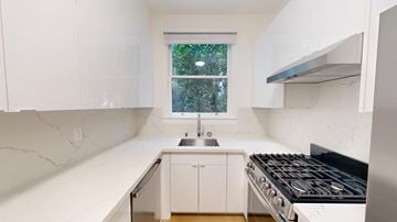 San Francisco apartment for rent - A white kitchen with a window and a stove.