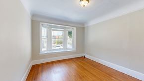 San Francisco apartment for rent - A room with a window and wooden floors.