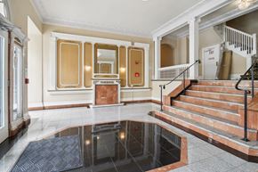 San Francisco apartment for rent - Grand entrance to a building featuring a large mirror above the fireplace and a staircase