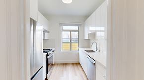 San Francisco apartment for rent - A modern kitchen with white appliances and cabinets.