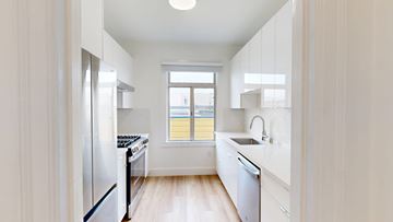 San Francisco apartment for rent - A modern kitchen with white appliances and cabinets.