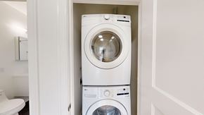 San Francisco apartment for rent - A white washing machine and dryer in a small laundry room.