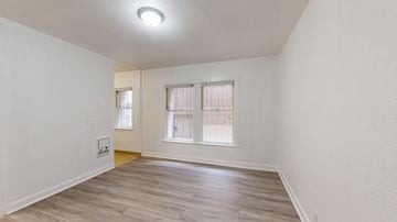 San Francisco apartment for rent - A room with a window and a wooden floor.
