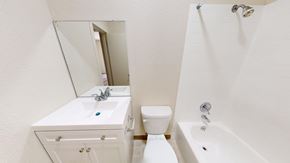 San Francisco apartment for rent - A white bathroom with a sink, toilet, and bathtub.