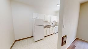 San Francisco apartment for rent - A kitchen with white appliances and cabinets.