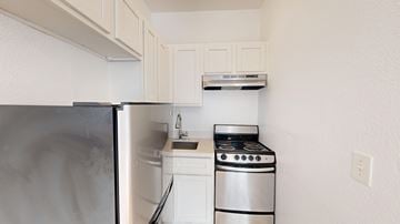 San Francisco apartment for rent - A small kitchen with a stove and a refrigerator.