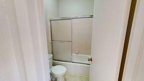 San Francisco apartment for rent - A white toilet sits next to a bathtub in a small bathroom.