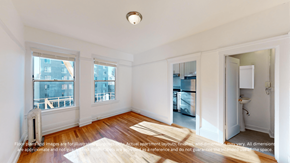 San Francisco apartment for rent - A room with a window, a door, and a radiator.