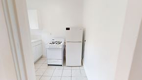 San Francisco apartment for rent - A white washing machine and dryer in a small laundry room.