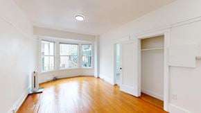 San Francisco apartment for rent - A room with a wood floor and a window overlooking a street.