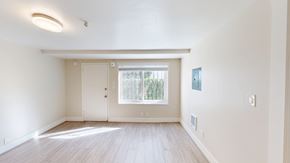 San Francisco apartment for rent - A spacious room with a door and a window.