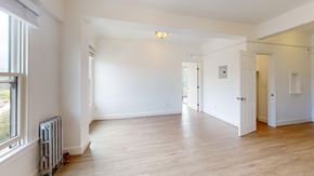 San Francisco apartment for rent - A spacious room with wooden floors and white walls.