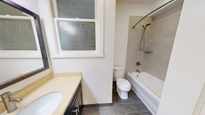 San Francisco apartment for rent - A white toilet sits in a bathroom next to a bathtub.