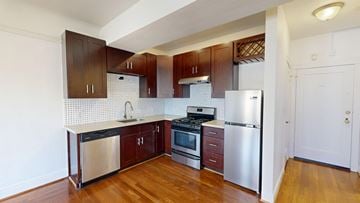 San Francisco apartment for rent - A kitchen with wooden cabinets and stainless steel appliances.