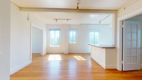 San Francisco apartment for rent - A large empty room with wooden floors and white walls.