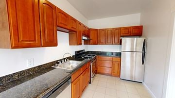 San Francisco apartment for rent - A kitchen with wooden cabinets and a stainless steel refrigerator.