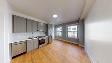 San Francisco apartment for rent - A kitchen with wooden floors and stainless steel appliances.