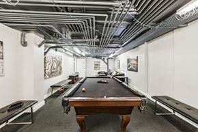 San Francisco apartment for rent - Basement room with pool table surrounded by a couch and a bench