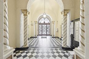 San Francisco apartment for rent - Hallway is illuminated by a chandelier hanging from the ceiling, casting a warm glow