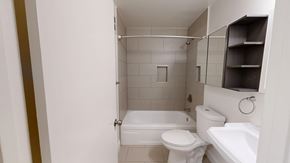 San Francisco apartment for rent - A white toilet is in a small bathroom with a white tub.