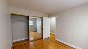 San Francisco apartment for rent - A room with a wooden floor and a large mirror on the wall.