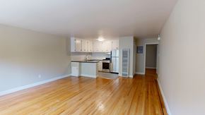 San Francisco apartment for rent - A kitchen with white cabinets and a black countertop.