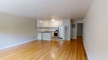 San Francisco apartment for rent - A kitchen with white cabinets and a black countertop.